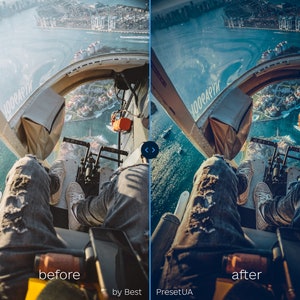 May include: A person wearing blue jeans and white sneakers sits in a helicopter with their legs dangling over the side. The helicopter is flying over a body of water with buildings and boats in the distance.