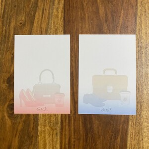 May include: Two blank note cards with a gradient background. The left card has a pink and red gradient and features a handbag, two high heels, and a coffee cup. The right card has a blue and light blue gradient and features a briefcase, a pair of shoes, and a coffee cup.