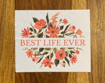 May include: White fabric square with a floral design in shades of pink and green. The text "BEST LIFE EVER" is printed in pink across the center of the fabric.