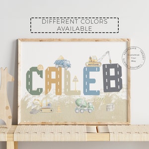 May include: A personalized name art print featuring the name "Caleb" in large, colorful letters with a construction theme. The letters are decorated with construction vehicles and road markings. The background is a light brown with a mountain range.