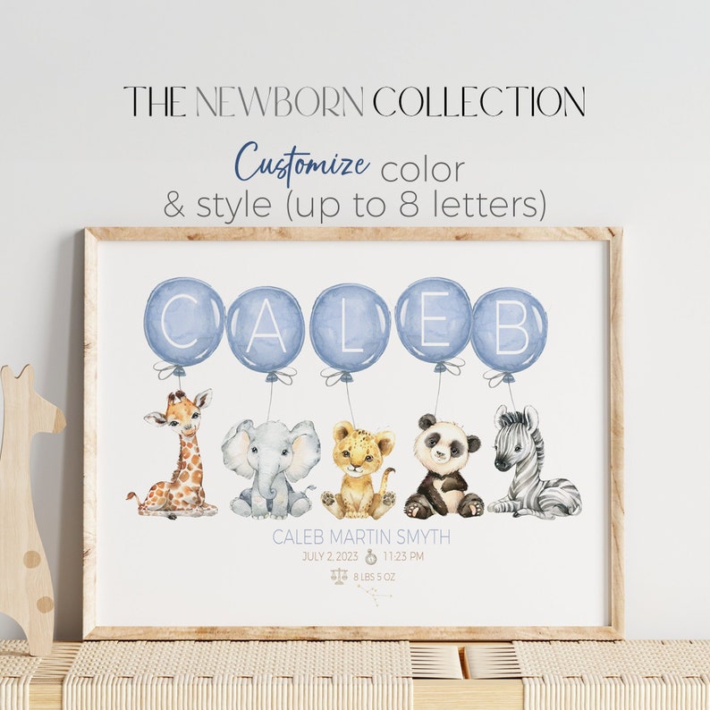 May include: A framed print featuring the name "CALEB" spelled out with blue watercolor balloons. Below the balloons are watercolor illustrations of a giraffe, elephant, lion cub, panda, and zebra. The text reads "THE NEWBORN COLLECTION".