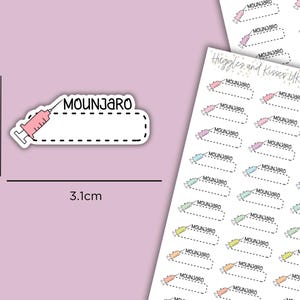 May include: A sticker with the word "MOUNJARO" and a syringe illustration. The sticker is 3.1cm long and 1.2cm high. Additional stickers with the same design are visible in the background. The stickers are on a light pink background.