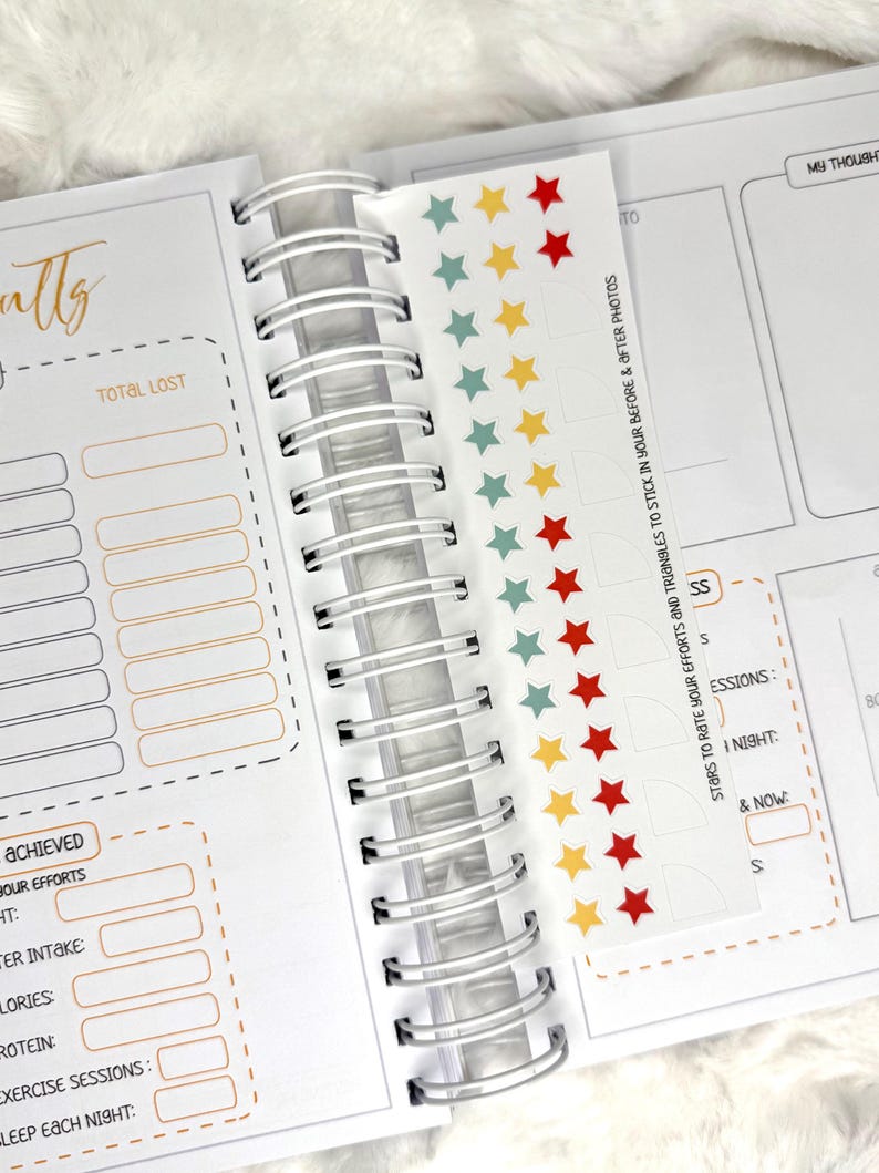 May include: Open spiral-bound planner with sections for tracking goals and results. Includes a sticker sheet with colorful star and triangle stickers. The planner has sections for water intake, calories, and exercise sessions.