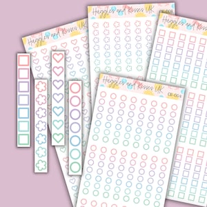May include: A set of colorful planner stickers with different shapes, including squares, circles, hearts, and flowers. The stickers are on white paper with a light pink background.