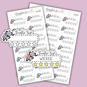 May include: Two sheets of stickers on a pale purple background. The stickers have the text "Theatre Trip" and a star rating system. One sticker says "WICKED" with yellow stars. The brand name "Huggles & Kisses" is at the top.