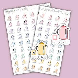 May include: A sheet of stickers featuring a cartoon kettle with a checkmark and the word "DESCALE" in a variety of colors. The stickers are designed for use in a planner or journal.