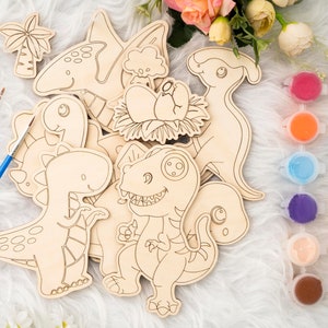 May include: Wooden dinosaur cutouts with paint pots and paintbrushes. The set includes various dinosaur shapes, such as a T-Rex, a Brontosaurus, and a Pterodactyl. The paint pots contain a variety of colors, including red, blue, and green.
