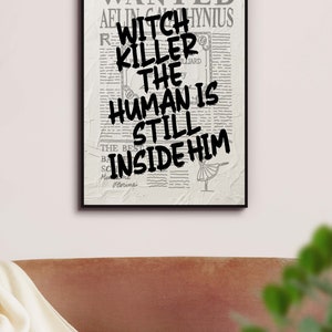May include: A black and white poster with the text "WANTED" at the top and the text "WITCH KILLER THE HUMAN IS STILL INSIDE HIM" in bold black letters.