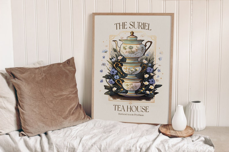 May include: A vintage-style poster with a teal teapot and teacups stacked on top of each other. The poster has a gold frame and the text "THE SURIEL TEA HOUSE Hottest Tea in Prythian" in a light blue font.