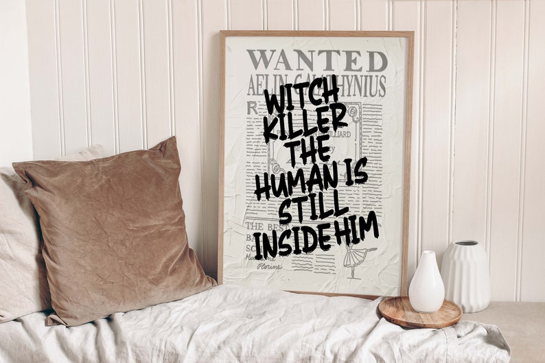 May include: A framed poster with a distressed newspaper background. The poster reads "WANTED AELIN GALANTHIS WITCH KILLER THE HUMAN IS STILL INSIDE HIM".
