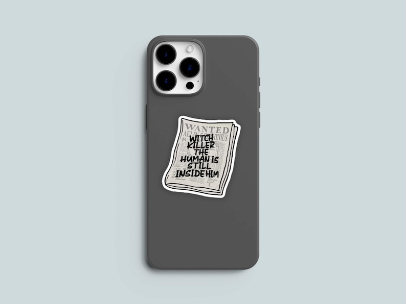May include: A gray phone case with a sticker of a newspaper headline that reads "WANTED WITCH KILLER THE HUMAN IS STILL INSIDE HIM".