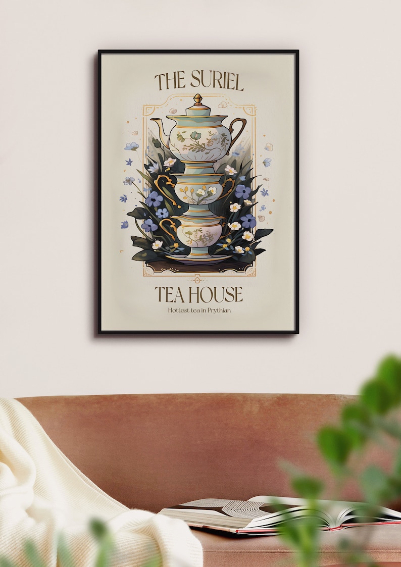 May include: A vintage-style poster with a black frame featuring a stack of teacups and a teapot with floral designs. The poster reads "The Suriel Tea House" and "Hottest tea in Prythian".