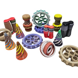 May include: A selection of brightly coloured mechanical components, including gears, screws, and cone shapes. The pieces display a variety of colours and patterns, such as red, yellow, blue, and brown, with detailed designs.