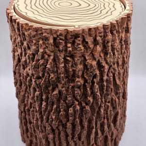 May include: A brown wooden log-shaped container with a removable lid. The lid has a light brown wood grain pattern.