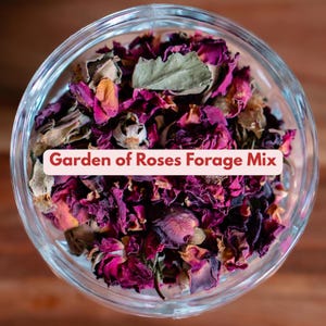 May include: A clear glass bowl filled with dried rose petals and leaves. The petals are various shades of pink and purple, with some tan and green leaves. Text on a pink banner reads "Garden of Roses Forage Mix."