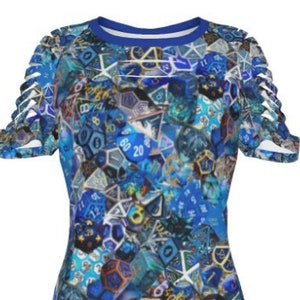 May include: A blue short-sleeved shirt with a print of various blue dice. The shirt has a distressed look with cutouts on the sleeves.