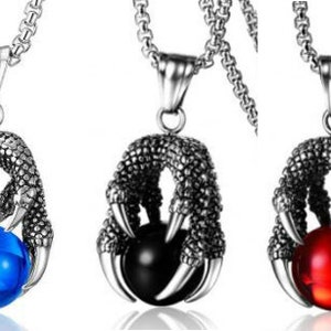 May include: Three silver dragon claw necklaces with different colored gemstones. The necklaces feature a detailed dragon claw design holding a round gemstone in the center. The gemstones are blue, black, and red.