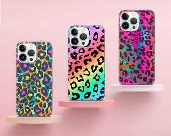 May include: Three iPhone cases with a leopard print design. The cases are in different colors, including pink, blue, and green. The cases are all on a pink background.
