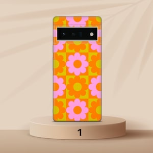 May include: A phone case with a retro-style pattern of orange and pink flowers on a yellow background.