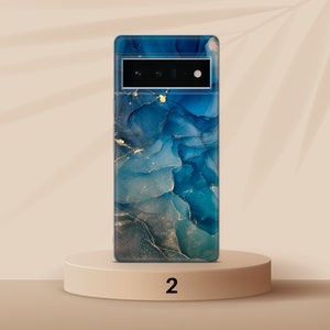 May include: A blue and gold abstract phone case with a camera cutout. The case is on a light brown pedestal with the number "2" printed on it.