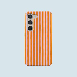 May include: A mobile phone case with a striped design. The case has vertical stripes in orange and light pink. The phone case has a camera array on the upper left side.