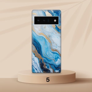 May include: A blue and gold abstract phone case with a camera cutout. The case is on a light brown pedestal.