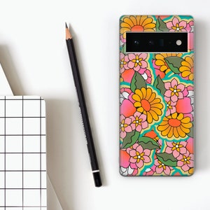 May include: A phone case with a colorful floral pattern. The flowers are pink, yellow, and orange with green leaves. The case has a cutout for the camera lens.