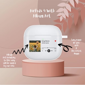May include: White AirPods case with a custom album art design. The case has a screen that displays the album art, song title, and artist name. The screen also has play and pause buttons.