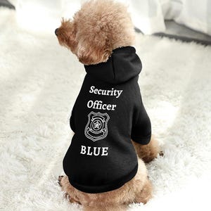 May include: A black hooded sweatshirt for dogs with the text "Security Officer BLUE" and a badge graphic.