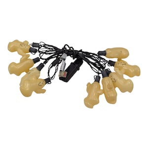 May include: A string of 10 clear, yellow ghost-shaped Christmas lights with black wires. The lights are strung together with a black wire and have a black plug.