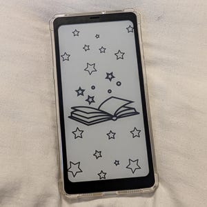 May include: A black and white illustration of an open book with stars on a white background. The image is on a clear phone case.