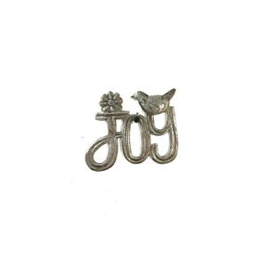 May include: Silver-toned metal brooch with the word "JOY" in a cursive font. A small bird sits atop the letter "Y", and a flower is above the letter "J". The brooch has a textured, detailed design and is set against a white background.