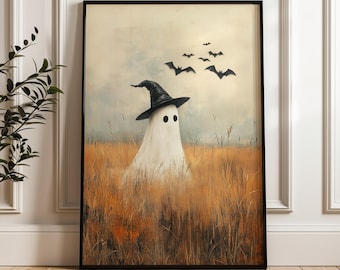 May include: A framed art print featuring a whimsical ghost wearing a black witch hat, standing in a field of tall, golden grass. Several black bats fly in the sky above the ghost, creating a spooky Halloween scene.