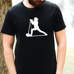 May include: A black t-shirt with a white silhouette of a person holding a microphone and standing on a stage.