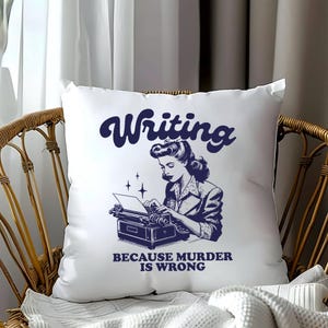 May include: White pillow with a blue illustration of a woman typing on a typewriter. The text "Writing because murder is wrong" is printed below the illustration.