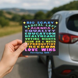 Może przedstawiać: Czarny kwadrat z kolorowym tekstem: "BIG SCARY RADICAL LEFT AGENDA EQUALITY EDUCATION HEALTHCARE VOTING RIGHTS CLEAN AIR & WATER REPRODUCTIVE FREEDOM LOVE WINS Terrifying, huh?"