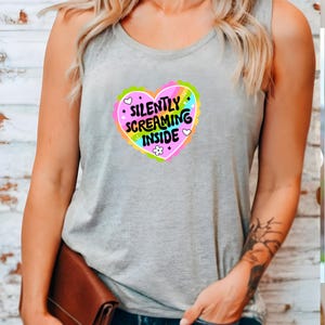 A racerback tank top with the phrase "Silently Screaming Inside" printed in bold, perfect for introverts and anyone navigating life with sarcasm and dry humor.