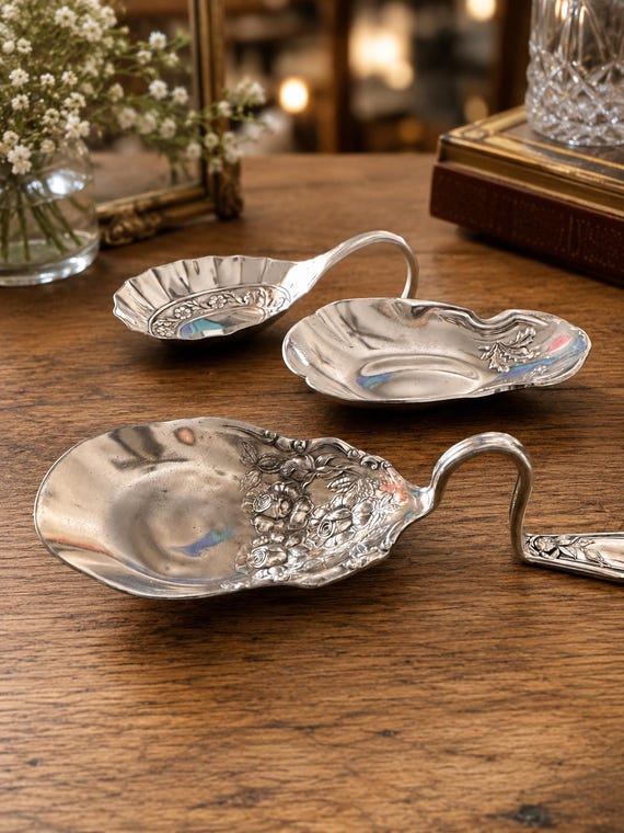 A vintage spoon bent and shaped into a one-of-a-kind ring/trinket tray — upcycled silverware craft that's genuinely clever and conversation-starting.