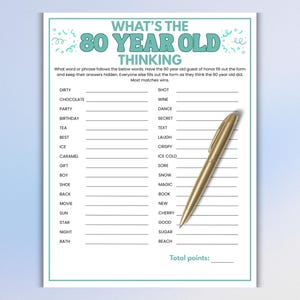 May include: A white paper game sheet titled WHAT'S THE 80 YEAR OLD THINKING with teal text and borders. The sheet features a list of words with blank lines for answers and a gold ballpoint pen resting diagonally across the right side of the page.