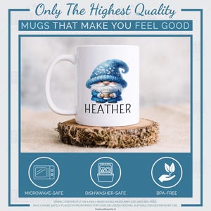 May include: A white ceramic mug with a blue gnome illustration and the name Heather. The mug is microwave safe, dishwasher safe and BPA free.