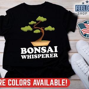 May include: Black t-shirt featuring a green bonsai tree graphic and the text "Bonsai Whisperer" in white.