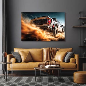 May include: A canvas print depicting a white off-road truck kicking up a cloud of orange dust. The truck is seen from the rear, with its taillights visible. The background features a dark blue sky and a hint of a landscape.