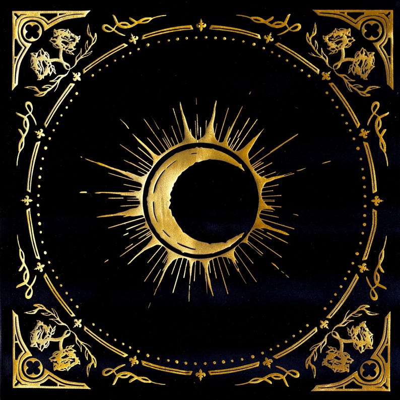May include: A black square background with a gold sun and crescent moon design. The design is surrounded by a gold ornate border with floral motifs.