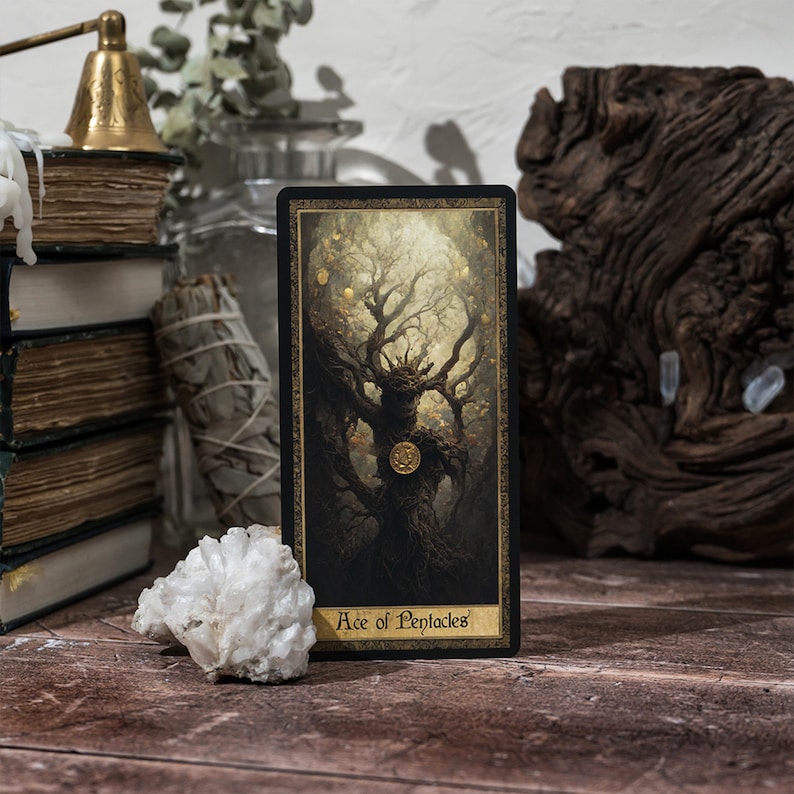 May include: A tarot card with a black background and gold accents. The card depicts a large, gnarled tree with a golden coin in the center. The text "Ace of Pentacles" is printed at the bottom of the card.