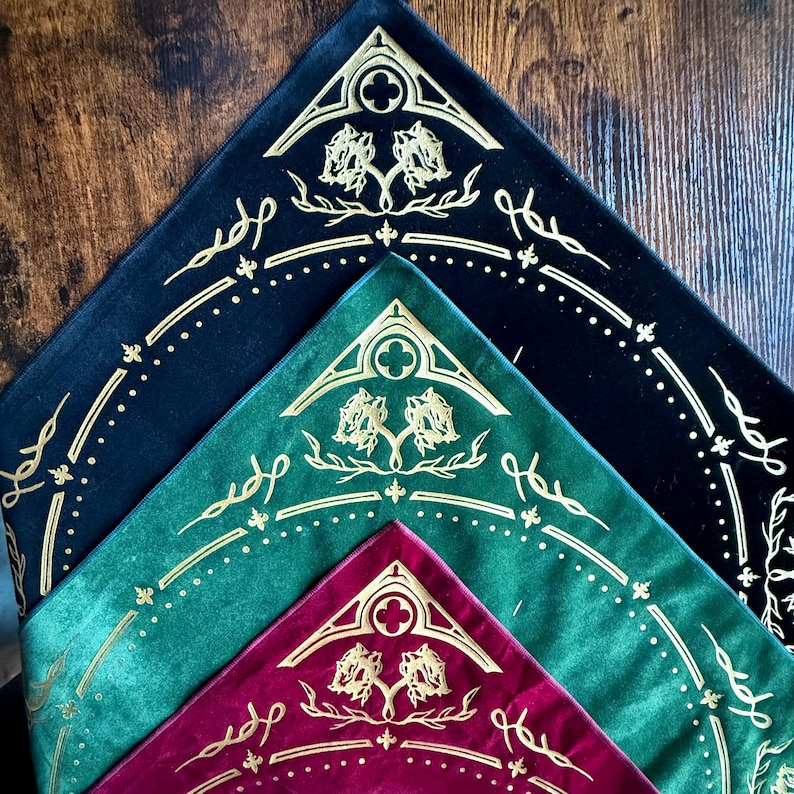 May include: Three fabric bandanas with a gold floral design on a black, green, and burgundy background.