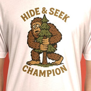 Funny Bigfoot T-Shirt – Hide and Seek Champion Tee – Retro Sasquatch Graphic Shirt – Vintage Cryptid Humor Tee for Men and Women