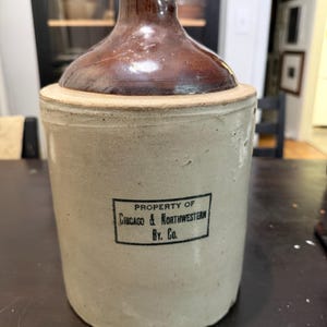 Antique 1-gallon Redwing stoneware advertising jug manufactured for the Chicago & Northwestern Railway Company