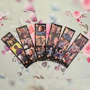 May include: A collection of six black bookmarks featuring images of various characters. Each bookmark has a series of images and is decorated with orange star accents. The bookmarks are arranged on a floral patterned surface.