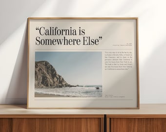 May include: A framed print with a beige background and a black and white image of a rocky beach with a quote that reads "California is Somewhere Else". The quote is attributed to Joan Didion, Notes from a Native Daughter.