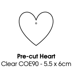 May include: A clear, pre-cut heart shape with a small hole at the top. The heart is outlined in black and measures 5.5 x 6 cm. The text "Pre-cut Heart" and "Clear COE90 - 5.5 x 6cm" are below the heart.